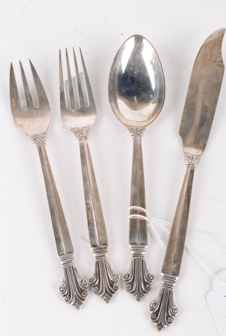 A Danish silver Acanthus (Dronning) pattern desser: A Danish silver Acanthus (Dronning) pattern dessert fork, a dessert spoon and a fish knife and fork by Georg Jensen, designed by Johan Rohde in 1917, import marked for London 1922, 1923 and 1924, 5.7
