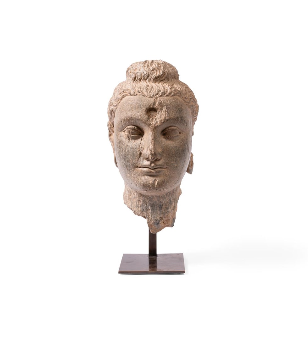 A GANDHARAN GREY SCHIST HEAD OF BUDDHA PESHAWAR VALLEY, PAKISTAN, 3RD OR 4TH CENTURY: A GANDHARAN GREY SCHIST HEAD OF BUDDHA PESHAWAR VALLEY, PAKISTAN, 3RD OR 4TH CENTURYhead 35cm high, set on modern stand, 41.5cm high overallProvenance:Jonathan Hope
