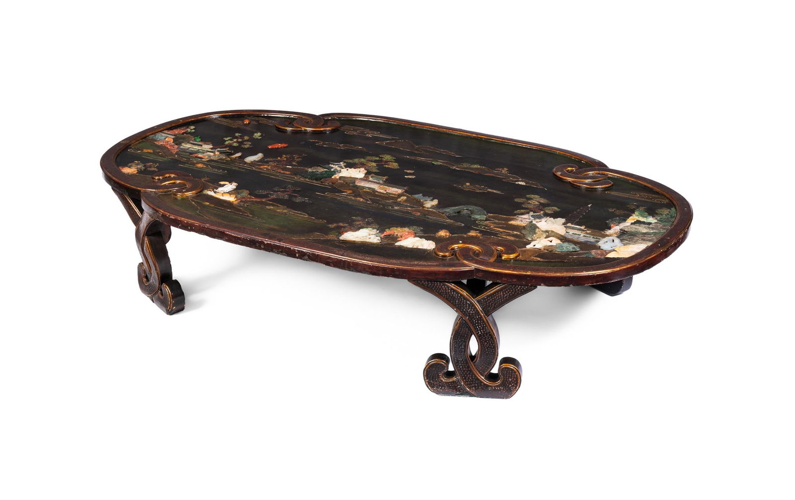 A HARDSTONE-MOUNTED LACQUERED OVAL PLAQUE, CHINESE, CIRCA 1930: A HARDSTONE-MOUNTED LACQUERED OVAL PLAQUECHINESE, CIRCA 1930Depicting figures in a river landscape with pagodas and pavilions and distant mountain peaks, in an interlaced red and gilt lacquered frame