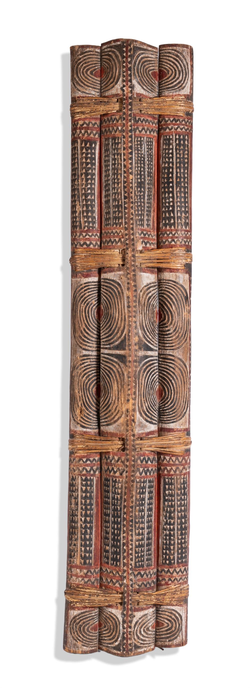 A NEW BRITAIN SHIELD, FIRST HALF 20TH CENTURY: A NEW BRITAIN SHIELD FIRST HALF 20TH CENTURYSet in three parts attached by four woven fibre bundles, all decorated with incised geometric decoration Provenance: Estate of Miriam Colon, actress, New
