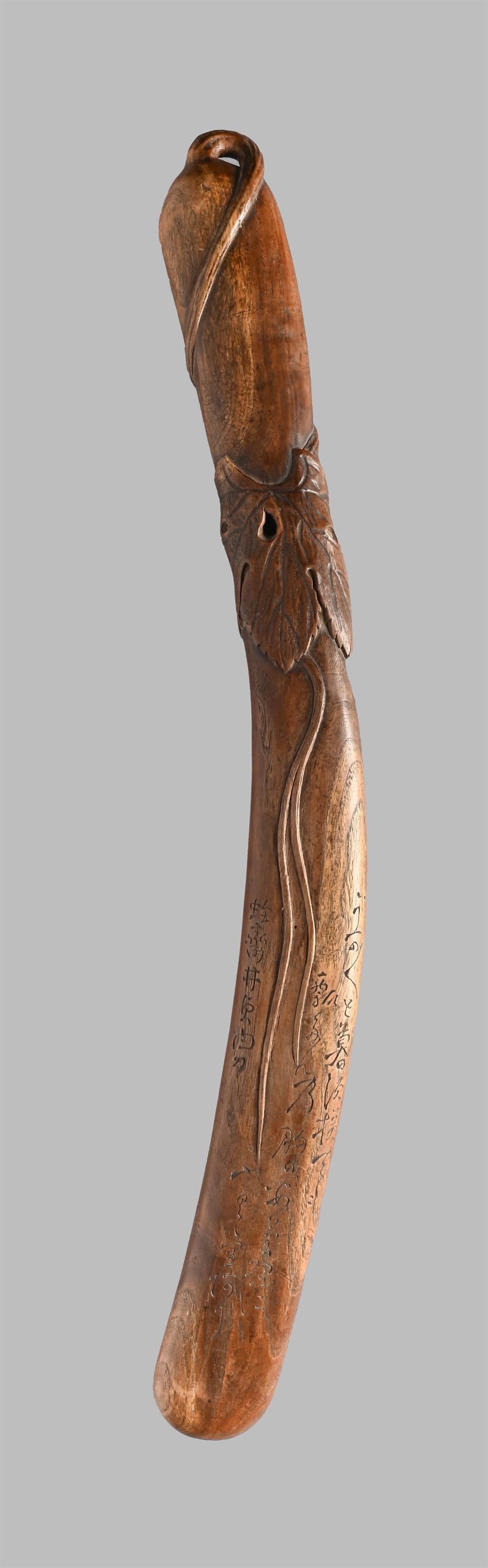 ‡ A wood bokuto [wooden sword], Edo period: ‡ Property from the Collection of Jean SaportaA wood bokuto [wooden sword]Edo period, 19th centuryin the form of an aubergine, carved in high and low relief with its encircled leaves and tendril