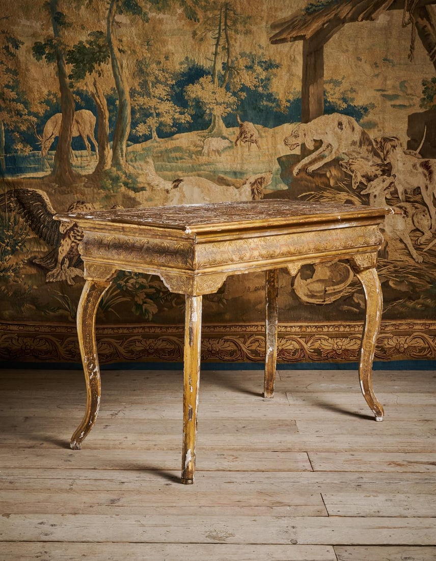 A GEORGE I GILT GESSO SIDE TABLE, IN THE MANNER OF JAMES MOORE, CIRCA 1720: A GEORGE I GILT GESSO SIDE TABLEIN THE MANNER OF JAMES MOORE, CIRCA 1720 The legs carved with pendant husks, the carved gilt gesso top centred with a monogram or cypher within a cartouche85cm high, 12
