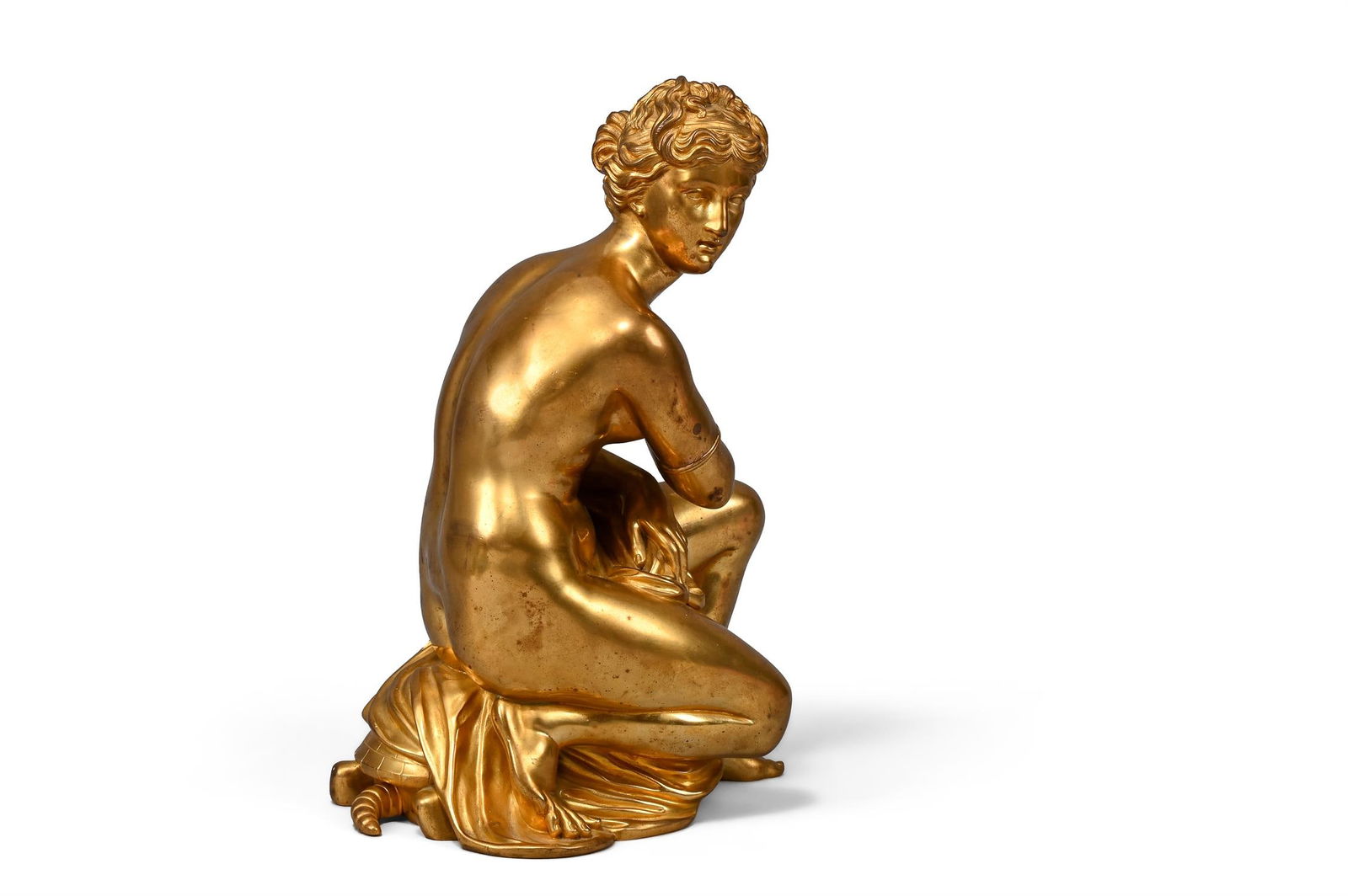 AFTER COYSEVOX, A GILT BRONZE FIGURE OF THE CROUCHING VENUS, FRENCH, 19TH CENTURY: AFTER COYSEVOX, A GILT BRONZE FIGURE OF THE CROUCHING VENUS FRENCH, 19TH CENTURY Portrayed semi clad in a flowing robe sat on a tortoise, J* 66 CTD mark to underside, possibly formerly a clock surmoun