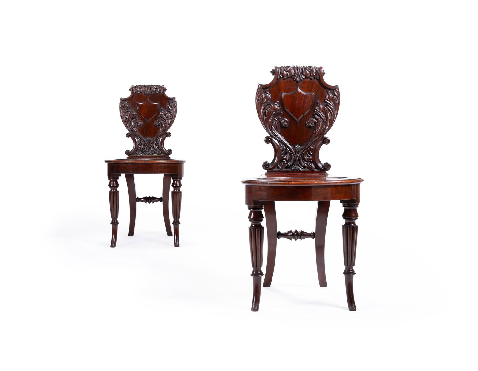 A PAIR OF GEORGE IV CARVED MAHOGANY HALL CHAIRS, IN THE MANNER OF GILLOWS, CIRCA 1830 (1 of 5)