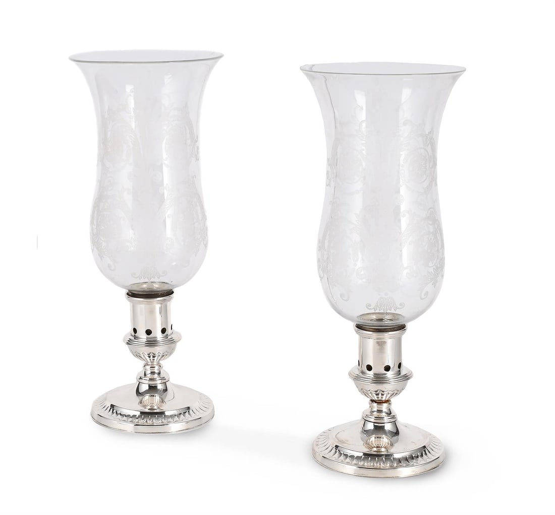 A PAIR OF ETCHED GLASS AND SILVER PLATE STORM LANTERNS OR 'PHOTOPHORES', EARLY 20TH CENTURY: A PAIR OF ETCHED GLASS AND SILVER PLATE STORM LANTERNS OR 'PHOTOPHORES' EARLY 20TH CENTURY Each with scrolling floral decorated shades above pierced circular bases 37cm high