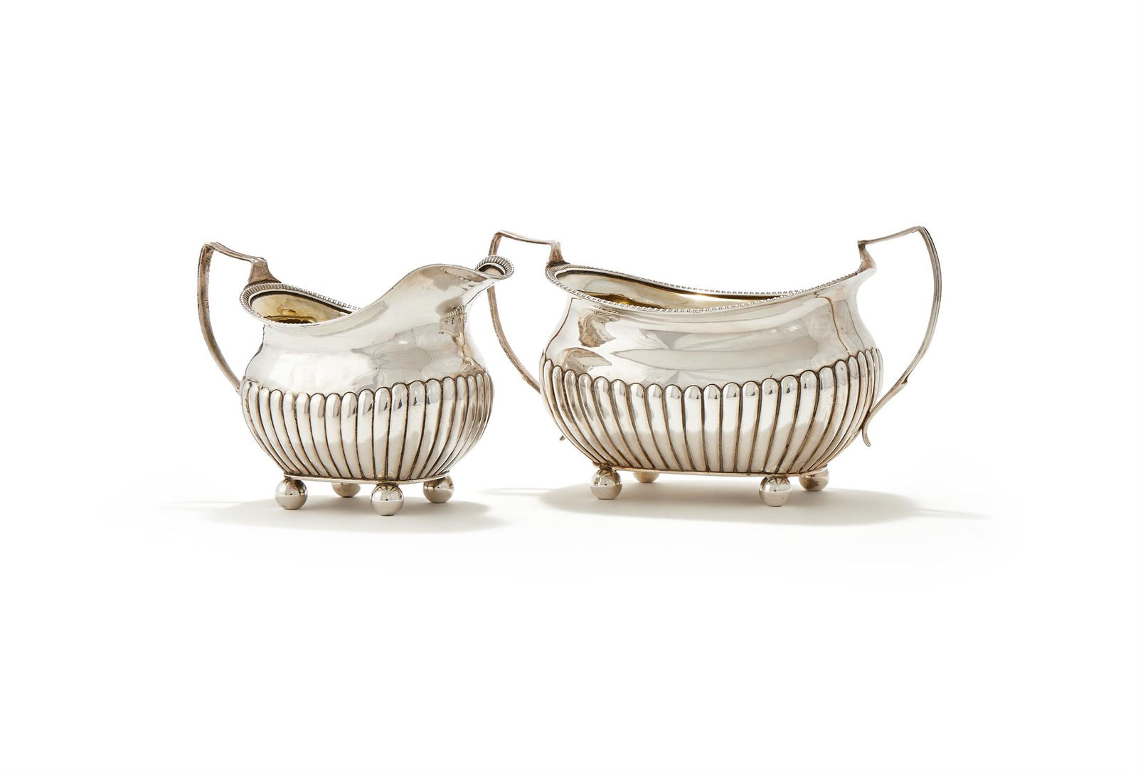 A GEORGE III SILVER LOBED OBLONG BALUSTER SUGAR BOWL AND MILK JUG (1 of 2)