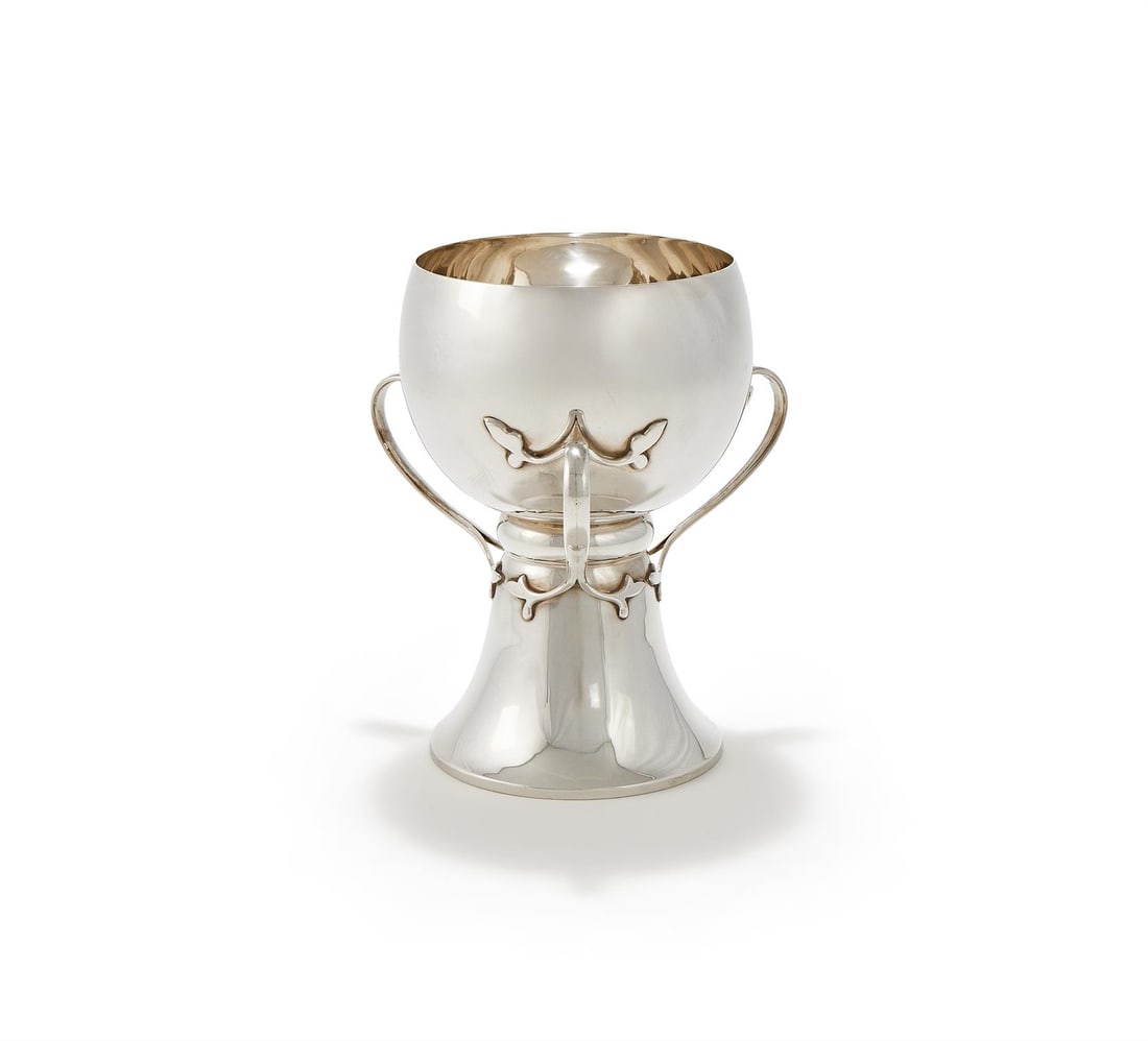AN EDWARDIAN SILVER THREE HANDLED CUP/VASE: AN EDWARDIAN SILVER THREE HANDLED CUP/VASEPEARCE & SON, CHESTER 1907 With three scroll handles and on a trumpet foot22cm high741g (23.85 oz) Provenance:An Anglo-French Collection Of Silver