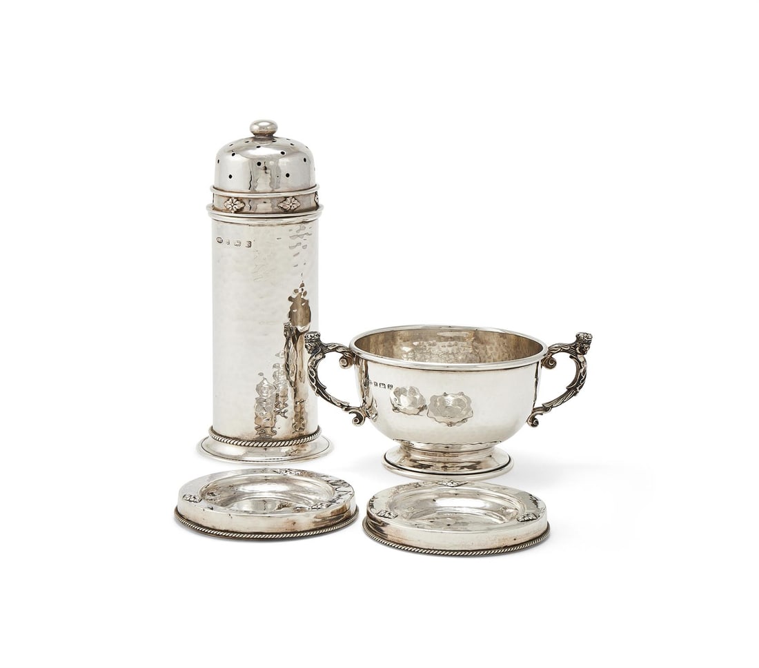 A CYLINDRICAL HAMMERED SILVER CASTER (1 of 3)