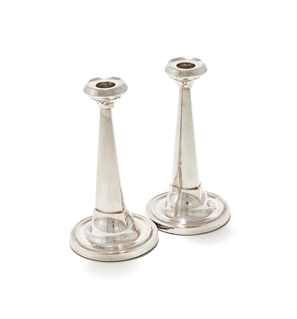 A PAIR OF SILVER TAPERING CANDLESTICKS: A PAIR OF SILVER TAPERING CANDLESTICKSWILLIAM GRIFFITHS & SONS, BIRMINGHAM 1921With circular capitals, tapering stems and on circular bases19.5cm highLoadedProvenance:An Anglo-French Collection Of Sil