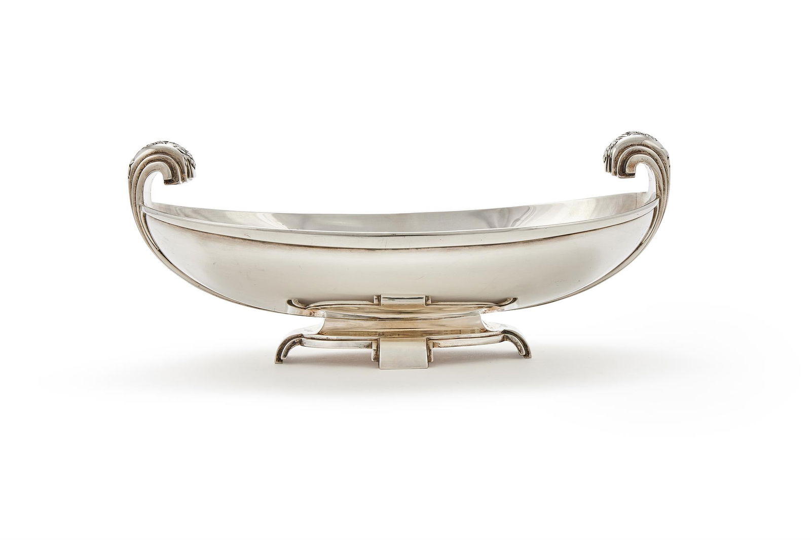 A SILVER TWIN HANDLED BOWL: A SILVER TWIN HANDLED BOWLEDWARD & SONS, BRIMINGHAM 1937 With twin floral chased scrolled handles and on four block feet33cm long1251g (40.2 oz)Provenance:An Anglo-French Collection Of Silver