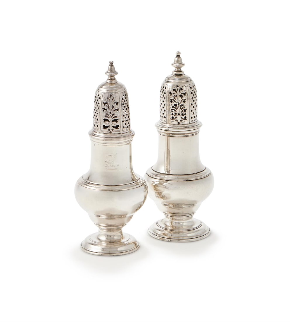 A PAIR OF GEORGE II SILVER BALUSTER CASTORS: A PAIR OF GEORGE II SILVER BALUSTER CASTORSSAMUEL WOOD, LONDON 1745 AND 1746With bell shaped finials to the pierced and domed covers, on circular moulded spreading feet15.5cm high310g (10 oz)
