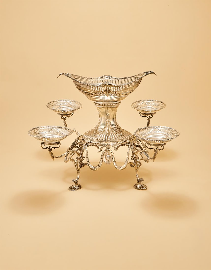 A GEORGE III SILVER EPERGNE: A GEORGE III SILVER EPERGNEEMICK ROMER, LONDON 1775The central shaped oval basket with a chased husk and shell border, the pierced body with a husk swag and medallion band, engraved 'From H.R.H. The P