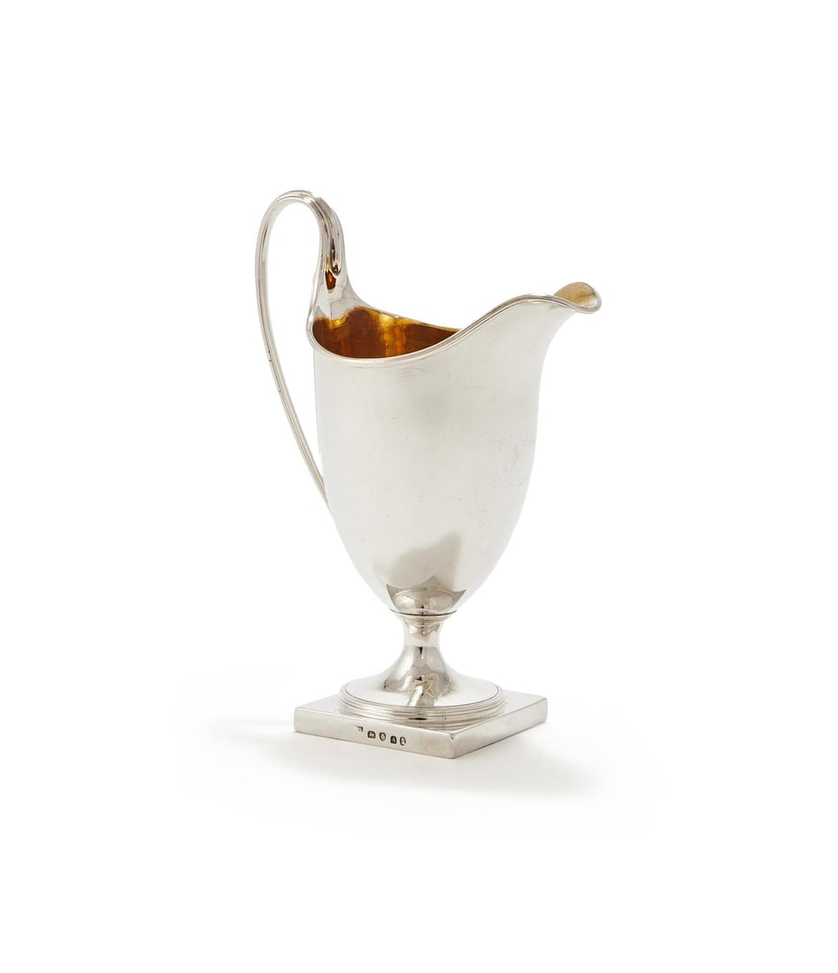 A GEORGE III SILVER HELMET CREAM JUG (1 of 2)
