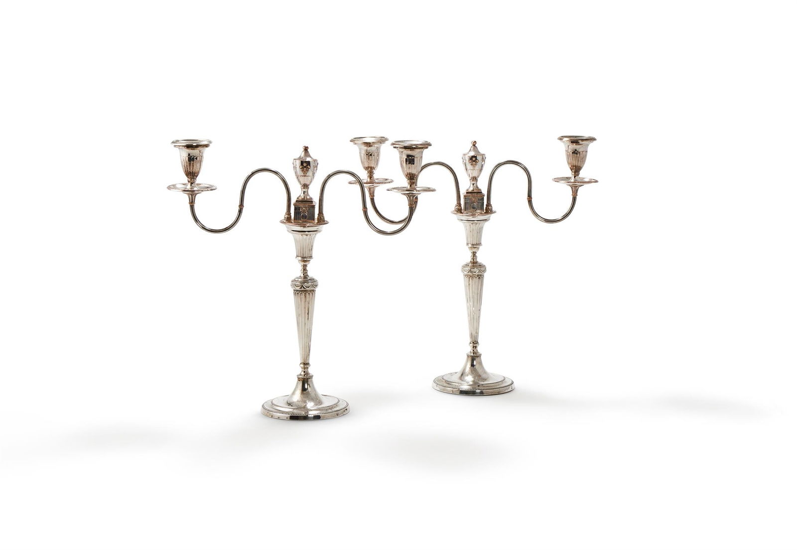 A PAIR OF GEORGE III SILVER CANDLESTICKS WITH OLD SHEFFIELD PLATED ARMS (1 of 2)