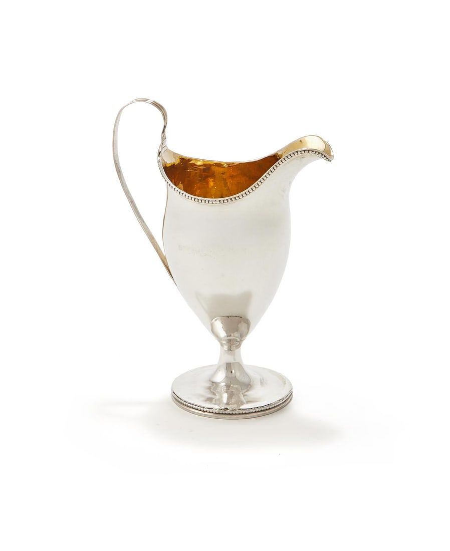 A GEORGE III SILVER CREAM JUG (1 of 2)