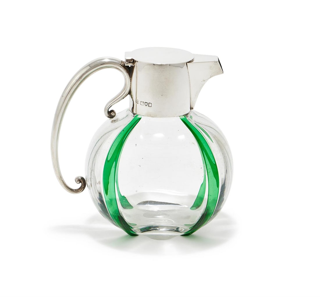 A VICTORIAN SILVER MOUNTED GLASS CLARET JUG: A VICTORIAN SILVER MOUNTED GLASS CLARET JUG MAPPIN & WEBB, LONDON 1900 With a flat cover and scroll handle, the globular body applied in green with vertical stripes16cm high