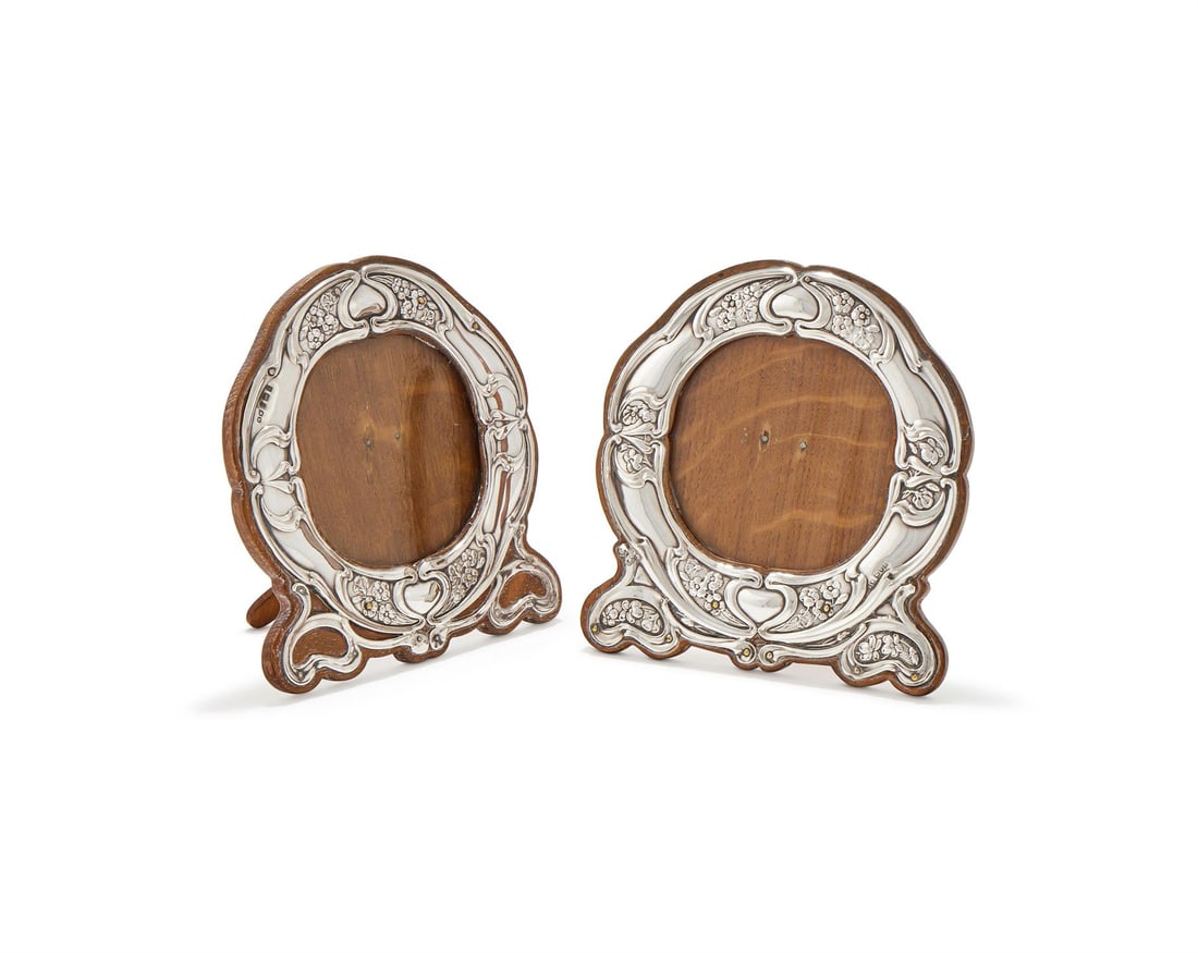 A MATCHED PAIR OF EDWARDIAN SILVER MOUNTED PHOTO FRAMES (1 of 2)