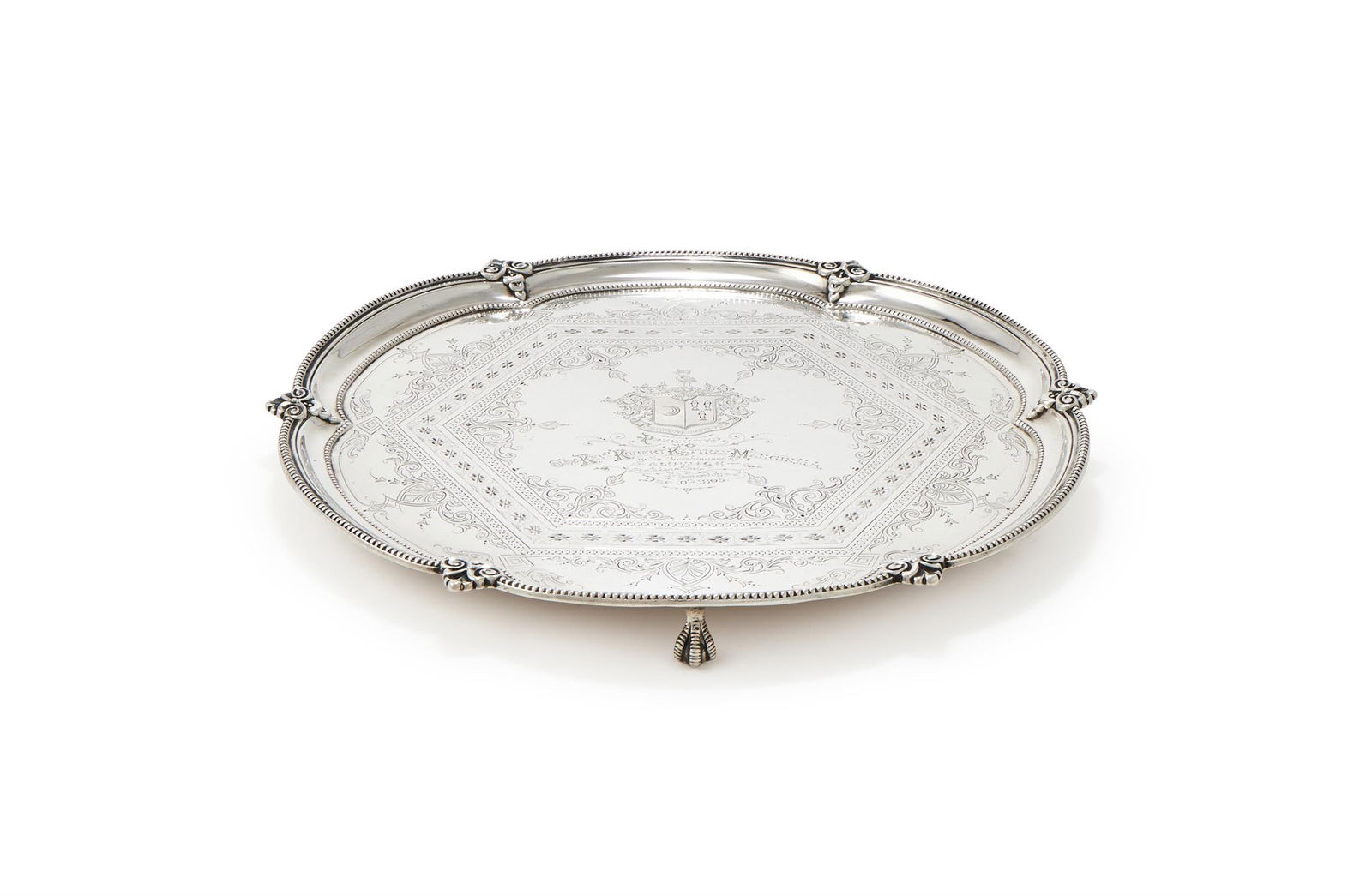 A VICTORIAN SILVER SHAPED CIRCULAR SALVER: A VICTORIAN SILVER SHAPED CIRCULAR SALVERFENTON BROTHERS (SAMUEL FENTON & ALFRED JOHN FENTON), SHEFFIELD 1888With a beaded border with scrolls at intervals, engraved with a decorative scroll band, an