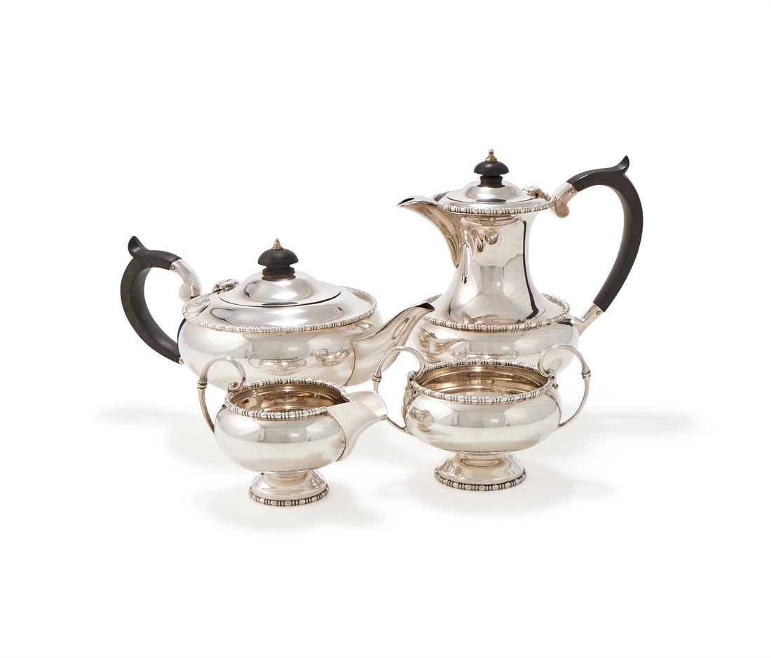 A SILVER CIRCULAR FOUR PIECE TEA SET (1 of 2)