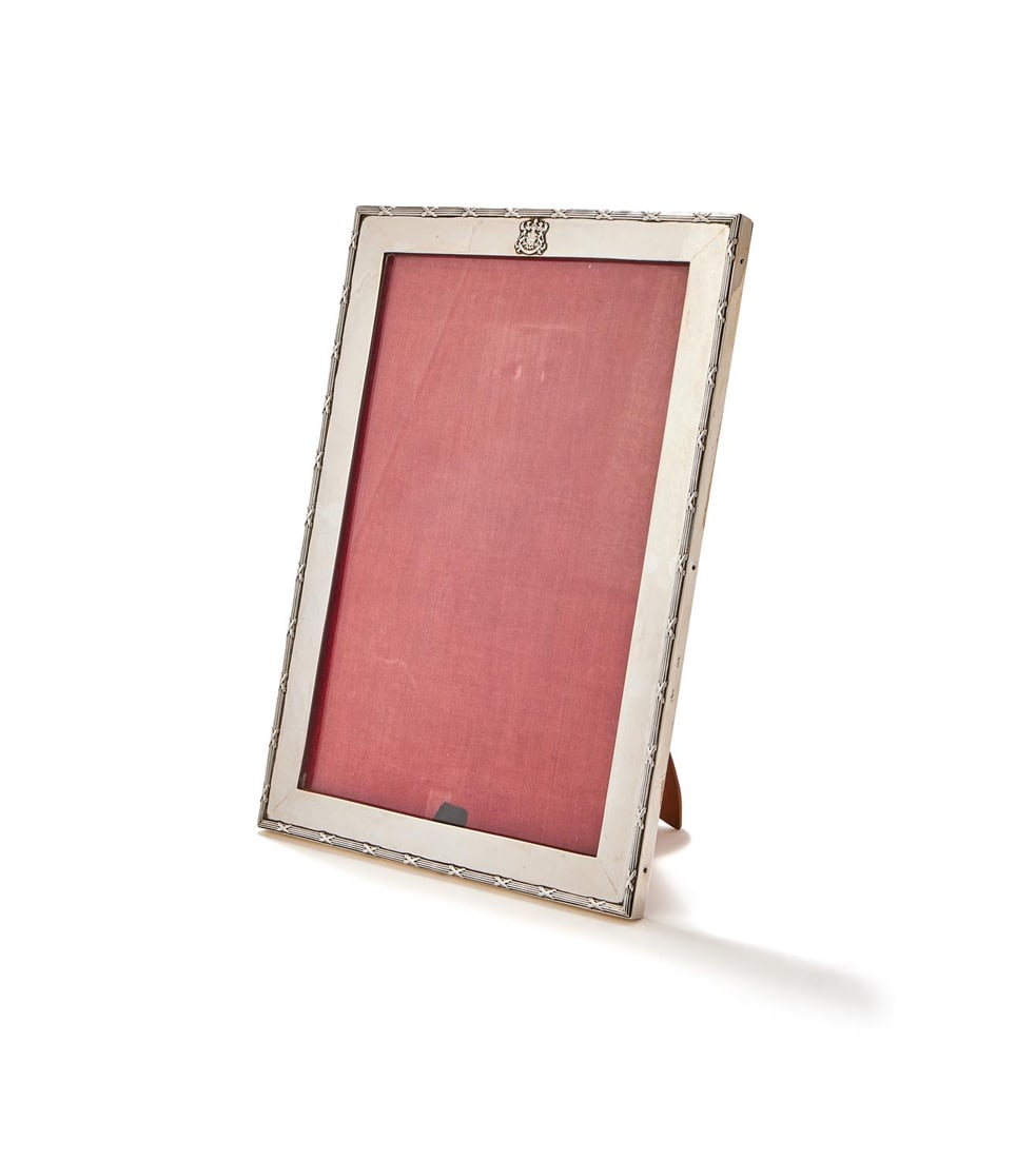 A SWEDISH SILVER MOUNTED PHOTO FRAME: A SWEDISH SILVER MOUNTED PHOTO FRAMEKVENNEFELDTS URWith a reed and stitch border, applied with an armorial35.5cm highProvenance:The Silver Collection From a Regent's Park Home, London