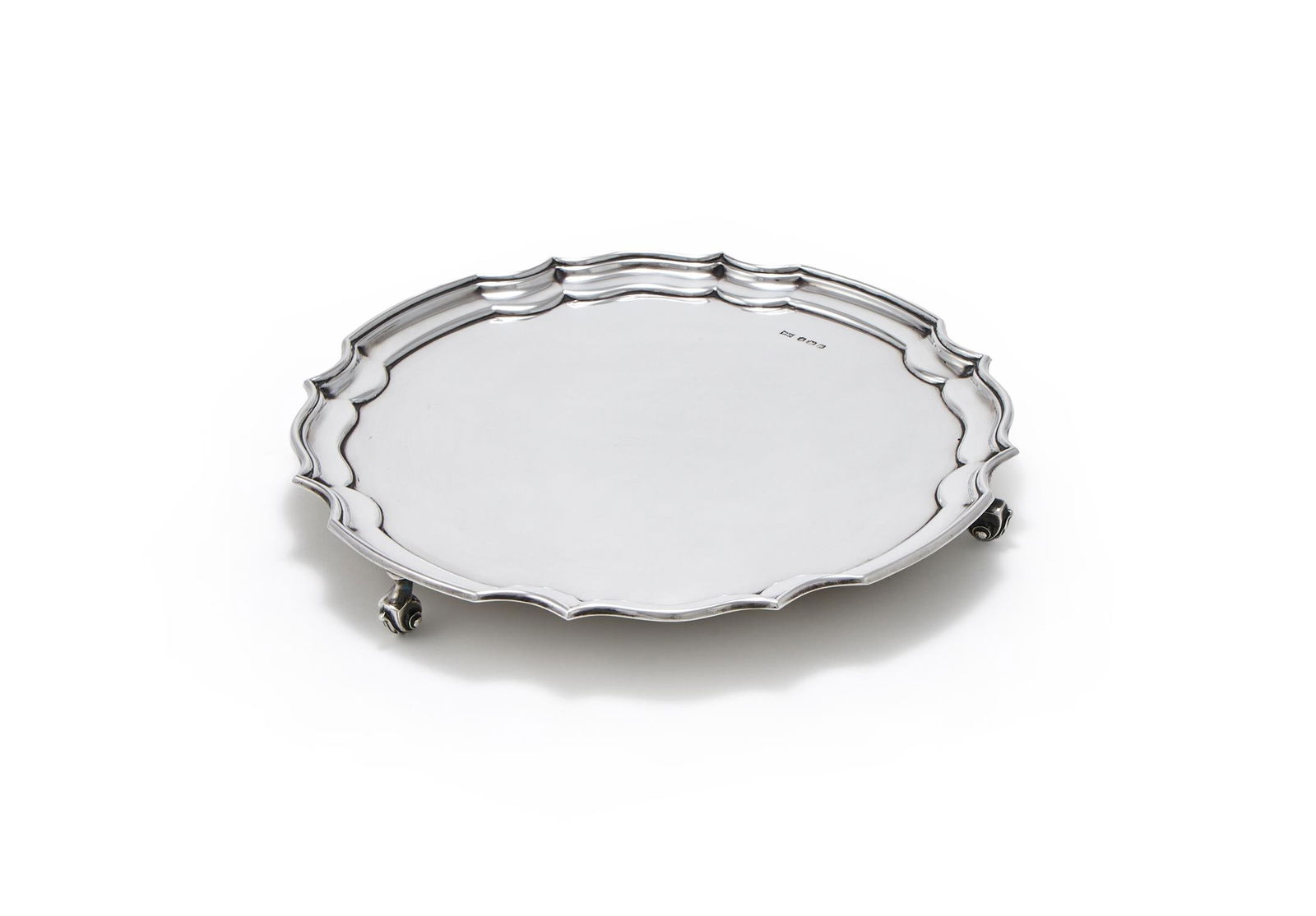 A SILVER SHAPED CIRCULAR SALVER (1 of 3)