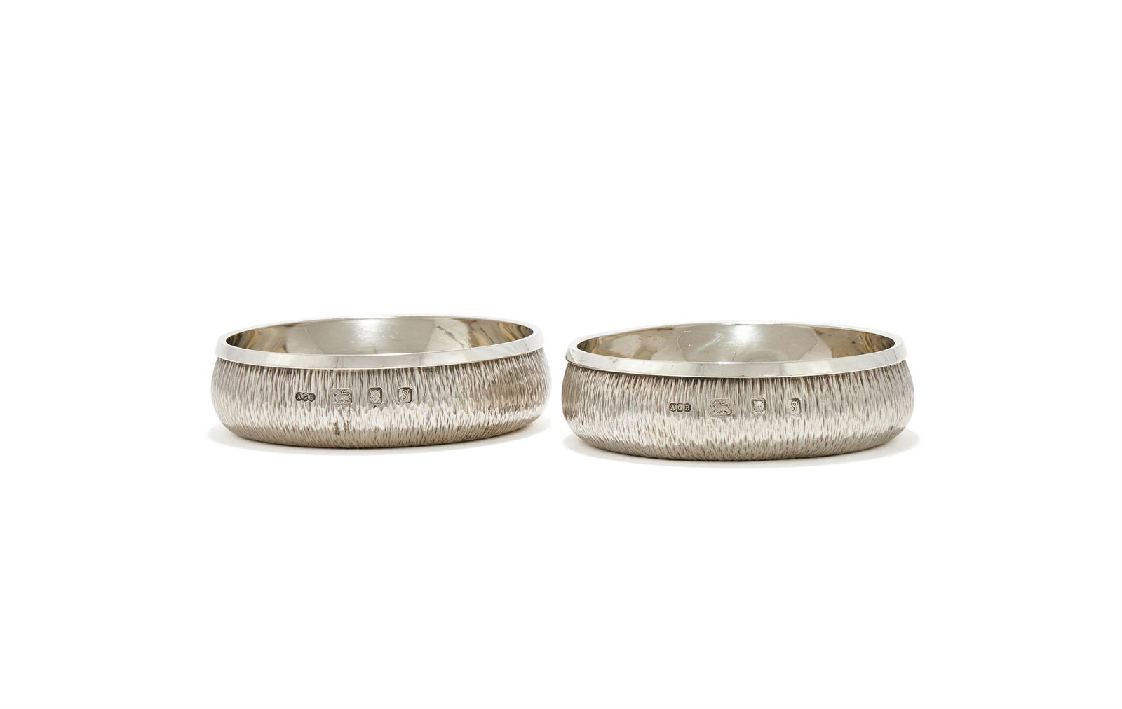 GERALD BENNEY, A PAIR OF SILVER AND SILVER GILT COASTERS: GERALD BENNEY, A PAIR OF SILVER AND SILVER GILT COASTERSLONDON 1973With inverted rims and textured finish10cm diameter337g (10.85 oz)