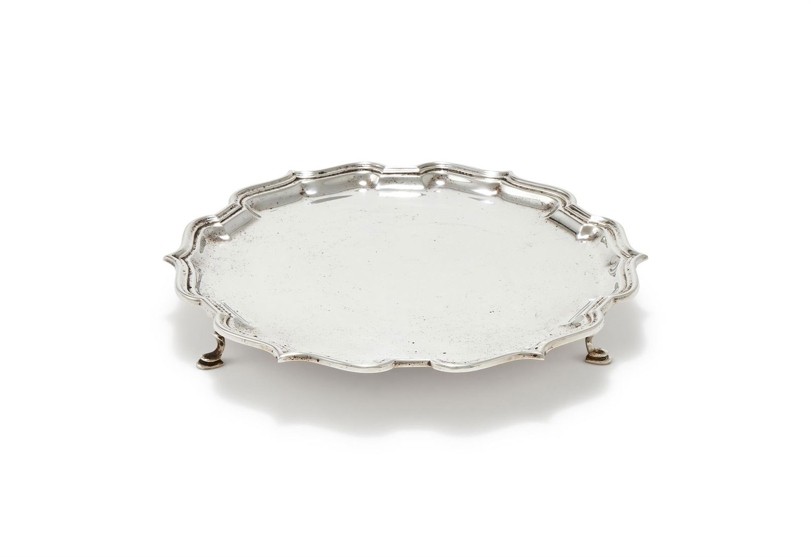 A SILVER SHAPED CIRCULAR WAITER (1 of 3)