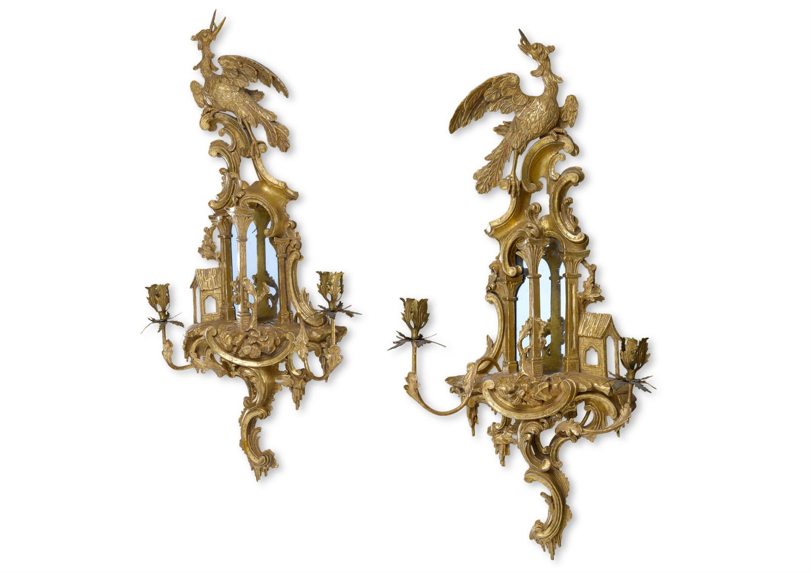 A PAIR OF GEORGE III CARVED GILTWOOD GIRANDOLES, CIRCA 1760: A PAIR OF GEORGE III CARVED GILTWOOD GIRANDOLESCIRCA 1760Each with a ho-ho bird cresting above an architectural frame carved with C-scrolls, foliage and rockwork and with twin branches and gilt metal