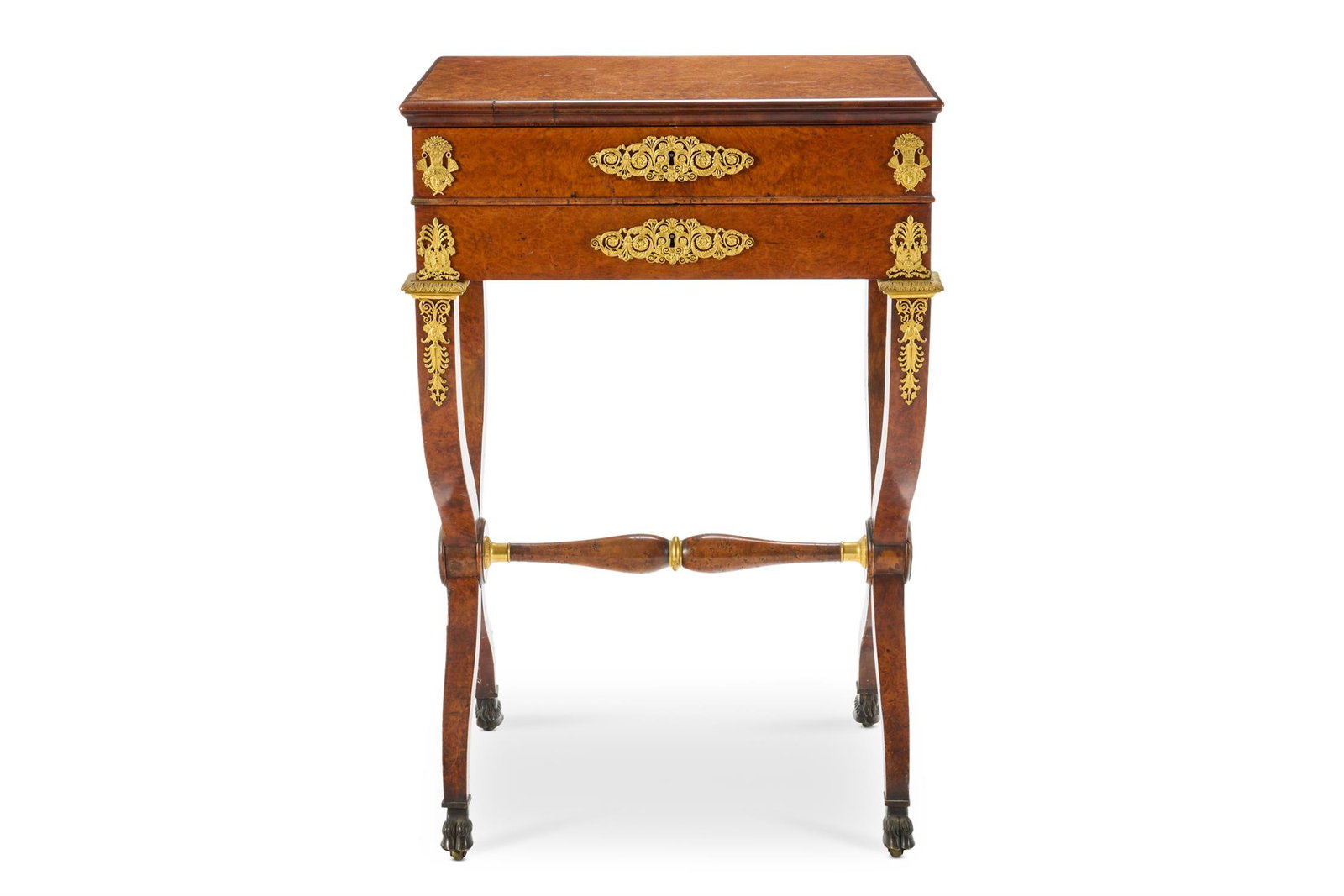 A LOUIS PHILIPPE GILT METAL MOUNTED AMBOYNA WORK TABLE, CIRCA 1840: A LOUIS PHILIPPE GILT METAL MOUNTED AMBOYNA WORK TABLECIRCA 1840The rectangular hinged top revealing a fitted interior with a drawer below on tapering X-shaped supports joined by a turned stretcher an