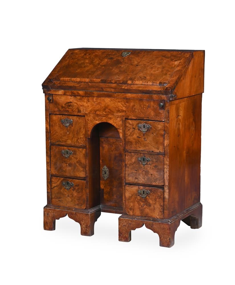 A WILLIAM III FIGURED WALNUT KNEEHOLE BUREAU, CIRCA 1700 (1 of 2)