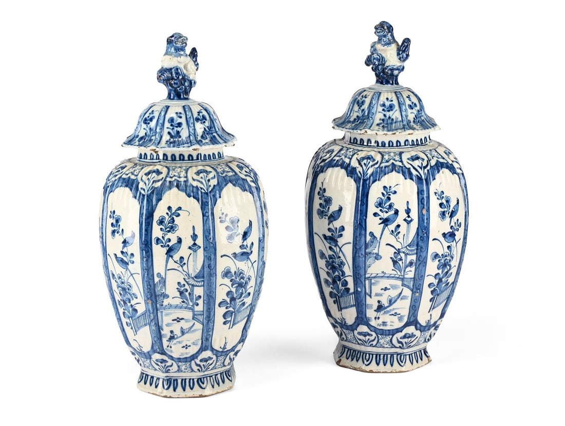 A PAIR OF DUTCH DELFT BLUE AND WHITE OCTAGONAL SECTION VASES AND COVERS, LATE 19TH CENTURY: A PAIR OF DUTCH DELFT BLUE AND WHITE OCTAGONAL SECTION OVOID VASES AND DOMED COVERS LATE 19TH CENTURY With blue script De Porceleyne Claeuw style mark and Fo dog finials each 44cm