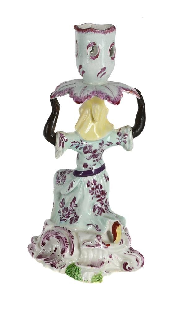 A BOW FIGURAL CANDLESTICK PROBABLY EMBLEMATIC OF AFRICA FROM A SERIES OF THE CONTINENTS, CIRCA 1760 - 2