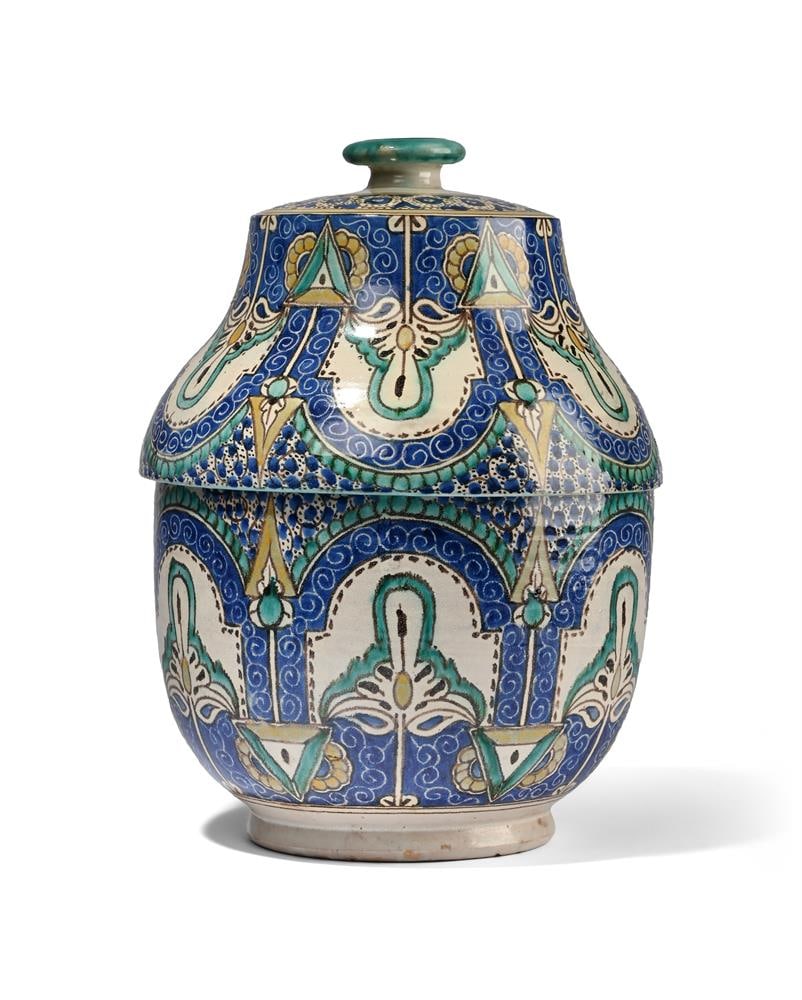 A MOROCCAN 'JOBBANA' DAIRY JAR AND COVER, EARLY 20TH CENTURY: A MOROCCAN 'JOBBANA' DAIRY JAR AND COVER EARLY 20TH CENTURY With repetitive Mihrab design 40cm high, 28cm diameter Condition Report: PLEASE NOTE: ALL LOTS ARE LOCATED AT SACKVILLE WEST
