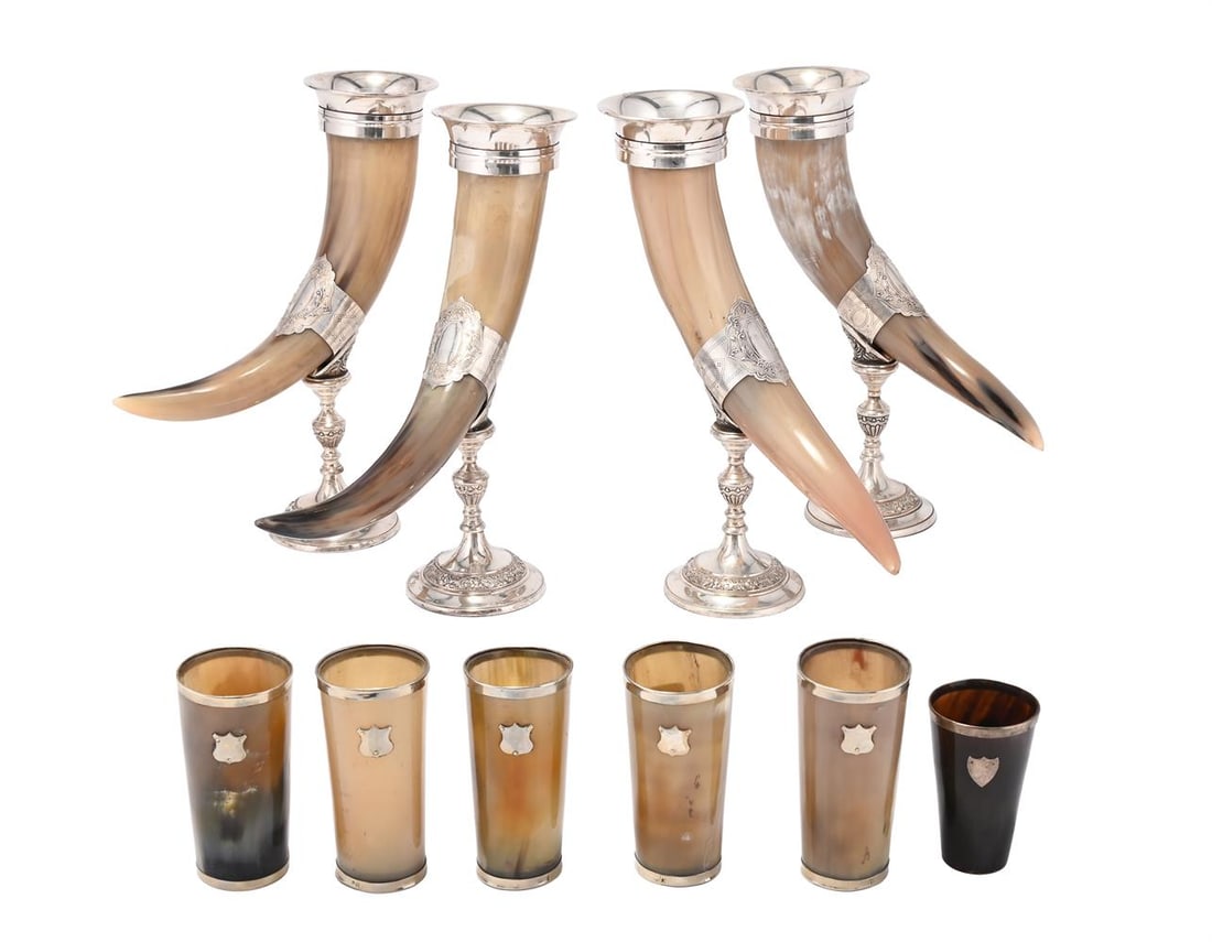 A SET OF FOUR SILVER PLATE DRINKING HORNS, TOGETHER WITH A SET OF SIX SIMILAR BEAKERS: A SET OF FOUR SILVER PLATE DRINKING HORNS MODERN 36cm high TOGETHER WITH A set of five similar beakers , modern, 13 x 6.5cm, and another smaller dark beaker, 10 x6.5cm 