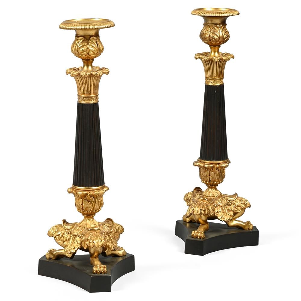 A PAIR OF PATINATED METAL AND GILT BRONZE CANDLESTICKS, LATE 19TH OR EARLY 20TH CENTURY (1 of 3)
