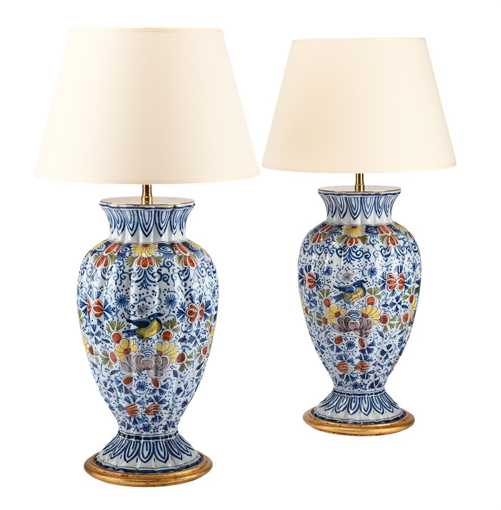 A PAIR OF DUTCH DELFT POLYCHROME OVOID AND GADROONED VASES, LATE 19TH OR EARLY 20TH CENTURY: A PAIR OF DUTCH DELFT POLYCHROME OVOID AND GADROONED VASES LATE 19TH OR EARLY 20TH CENTURY Later adapted as lamps for electricity, painted with birds and flowers the vases 37cm