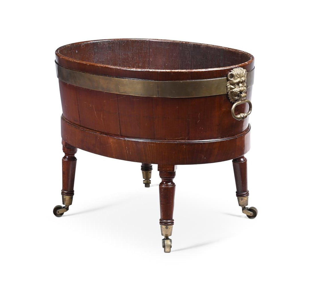 A LATE GEORGE III MAHOGANY BRASS BOUND WINE COOLER AND STAND, FIRST QUARTER 19TH CENTURY: A LATE GEORGE III MAHOGANY BRASS BOUND WINE COOLER AND STAND FIRST QUARTER 19TH CENTURY 47cm high, 64cm wide, 44cm deep Provenance: Provided by Robert Kime Ltd. 