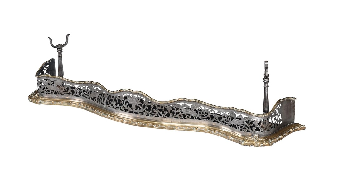 A GILT METAL AND BRUSHED STEEL SERPENTINE FENDER, FIRST HALF 19TH CENTURY: A GILT METAL AND BRUSHED STEEL SERPENTINE FENDER FIRST HALF 19TH CENTURY With integral fire iron stirrup supports 35cm high, 159cm wide, 33cm deep Condition Report: 