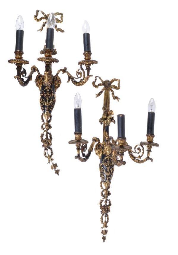 A pair of gilt and patinated metal three light wal