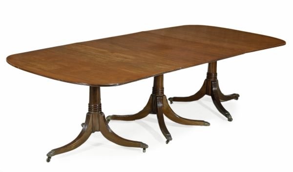 A mahogany extending triple pillar dining table,