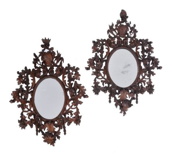 A pair of North Italian Rococo carved walnut oval
