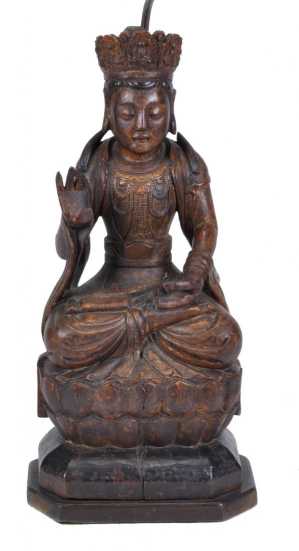 A Chinese carved wood figure of a deity , in Ming
