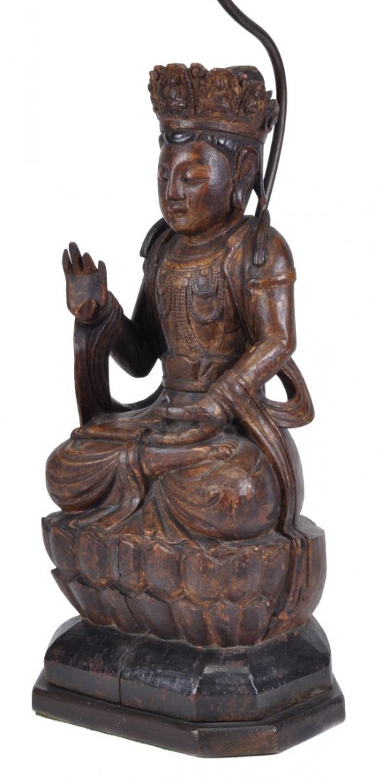 A Chinese carved wood figure of a deity , in Ming - 2