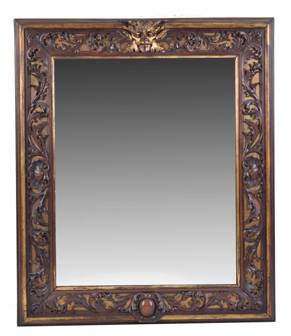 An Italian carved walnut framed and parcel gilt wa