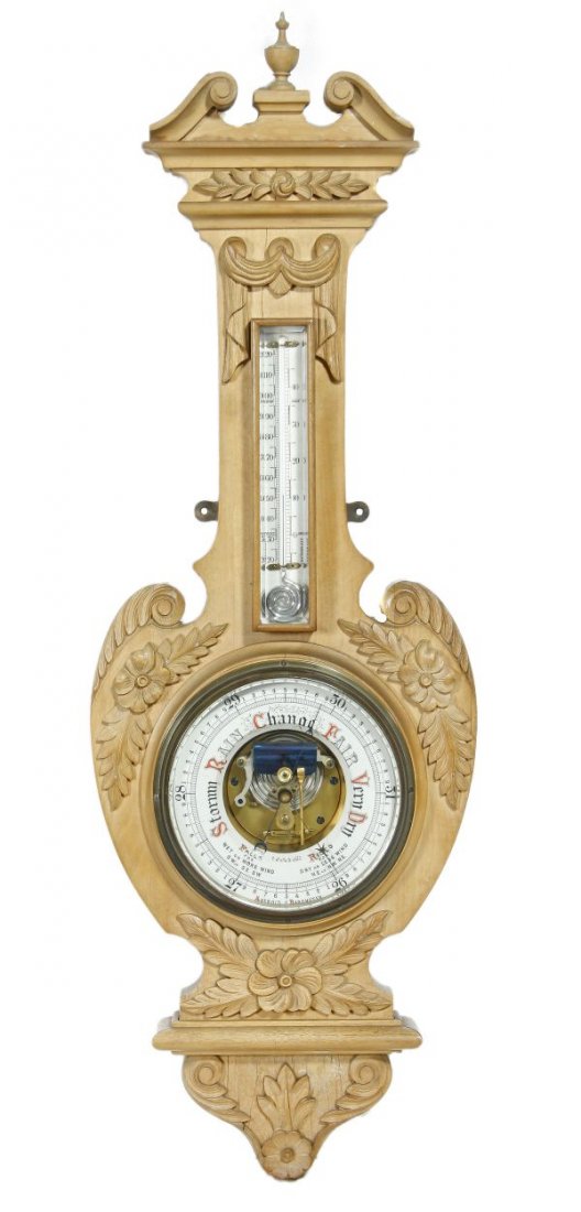 A Victorian carved beech aneroid barometer and the