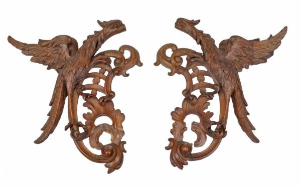 A pair of Italian carved and stained softwood wall