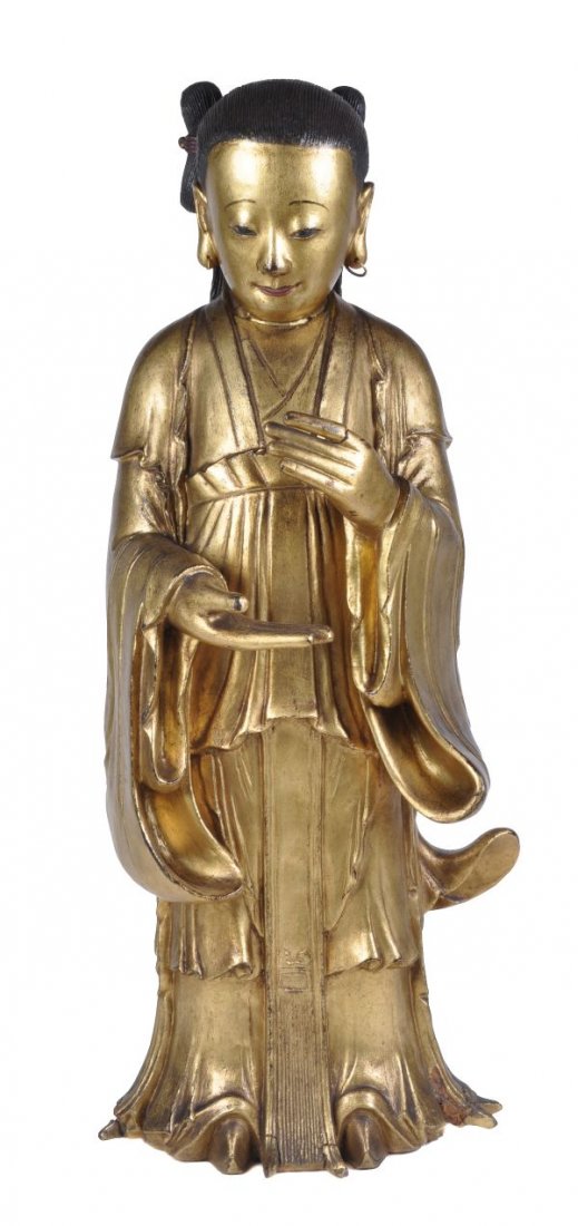 A South East Asian gilt wood figure of an attendan
