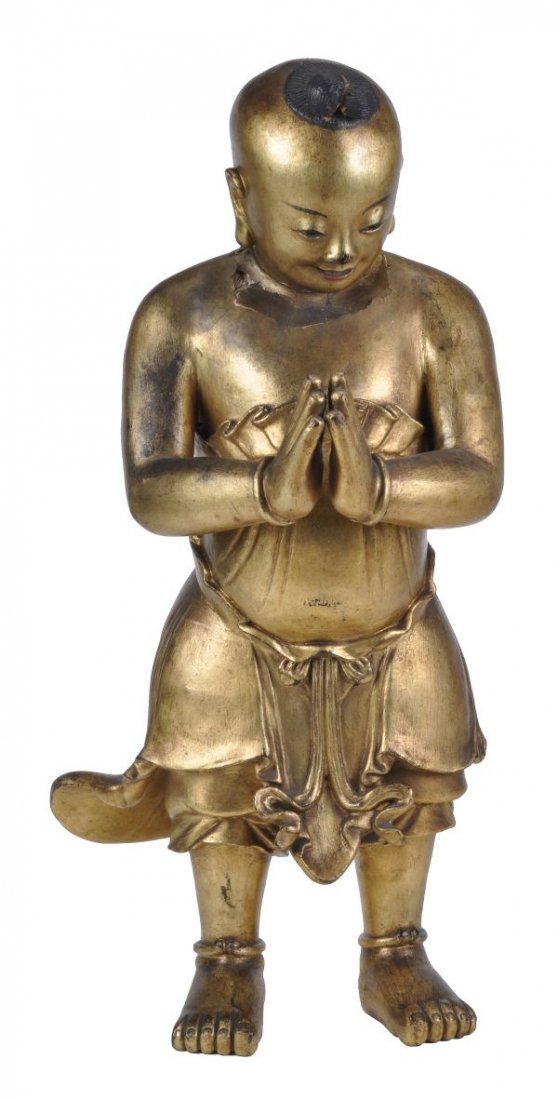 A South East Asian giltwood figure of a boy , late