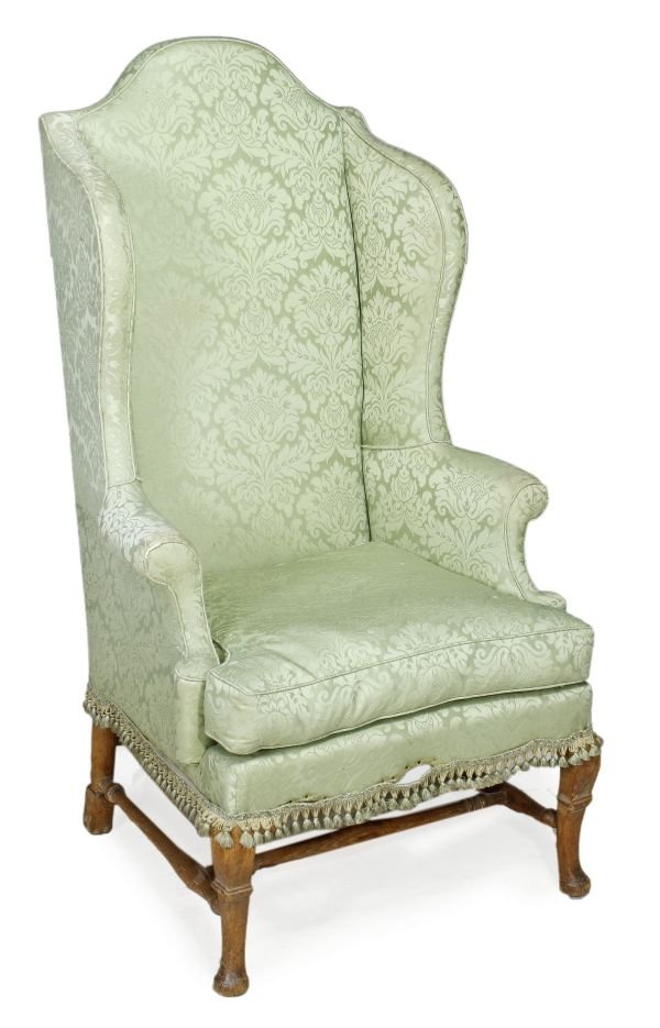 A green damask upholstered and stained oak wing ar