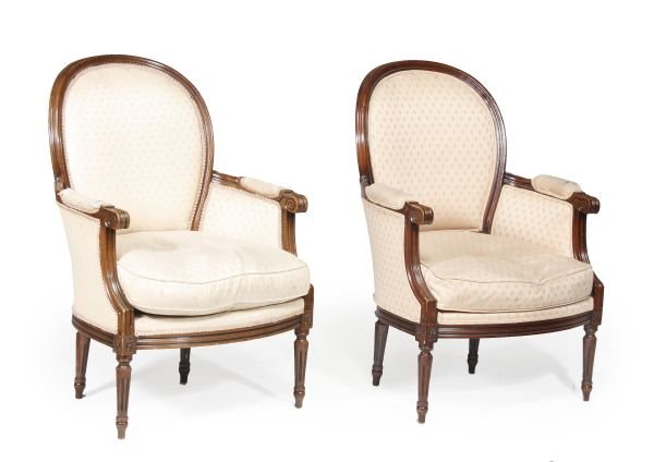 A pair of stained beech and upholstered armchairs,